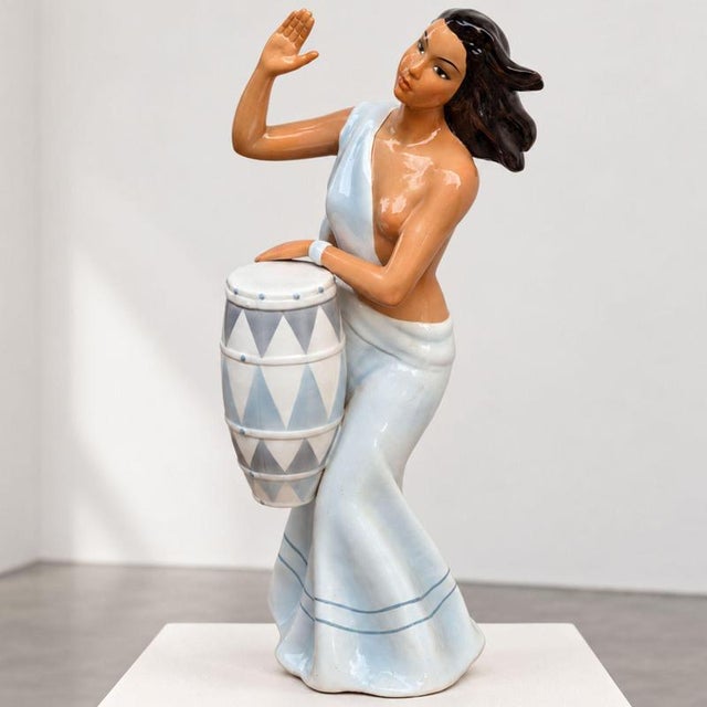 A rare Italian polychrome glazed ceramic sculpture from the 1950s by Ronzan, depicting a woman playing a drum. The figure...