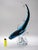 A truly wonderful glass sculpture of a shark surfing on the wave. The light reflects so beautifully, and the blue color...
