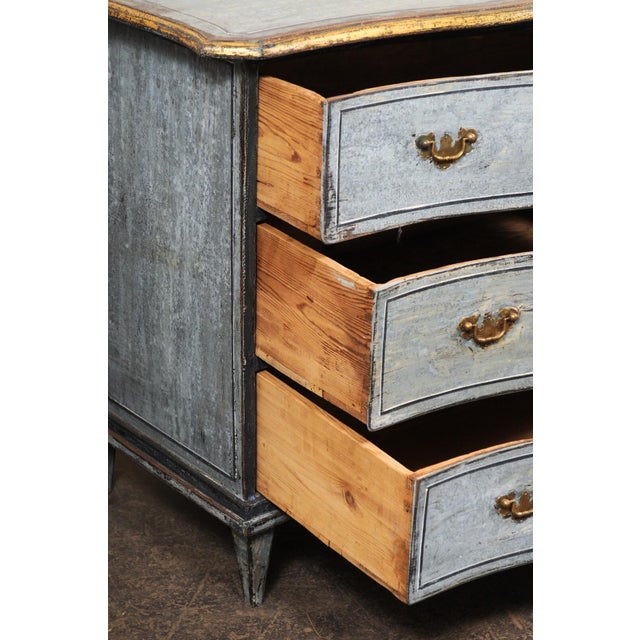 A French shapely serpentine painted wood commode of three drawers from the 19th century. This antique chest from France...