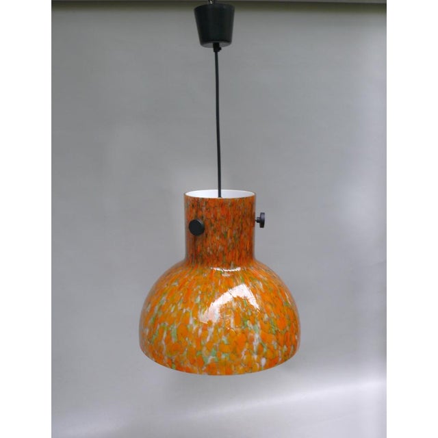 A modern and stylish ceiling light, manufactured by peill & putzler in the 1970s in a typical color combination of the...