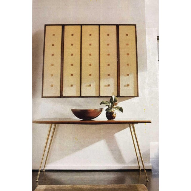 Walnut hanging cabinet by Bert England for Johnson Furniture. Brass decorative detail, leather front doors. This is stunning!