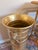 A handsome vintage hammered brass umbrella stand featuring classic lion head ring handles and a beautifully aged brass...