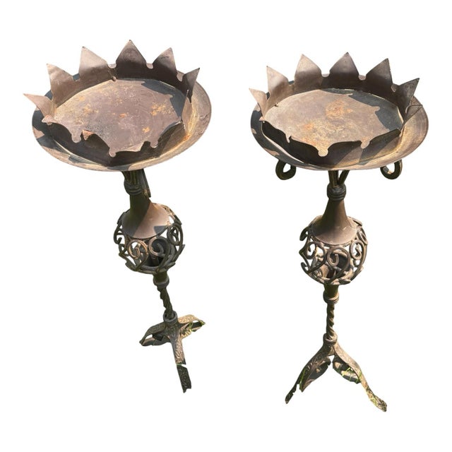 A striking pair of vintage mid-century wrought iron jardinière stands featuring beautifully sculptural metalwork and an...