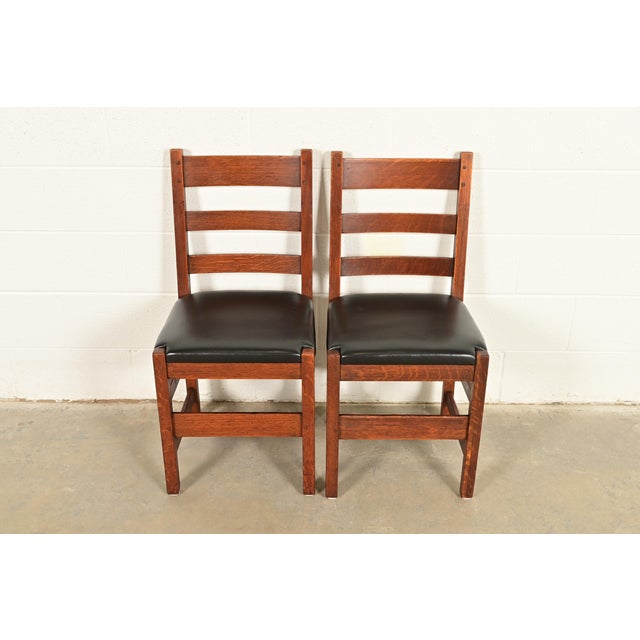 An exceptional pair of antique Mission or Arts & Crafts period ladder back side chairs or dining chairs By L. & J.G....