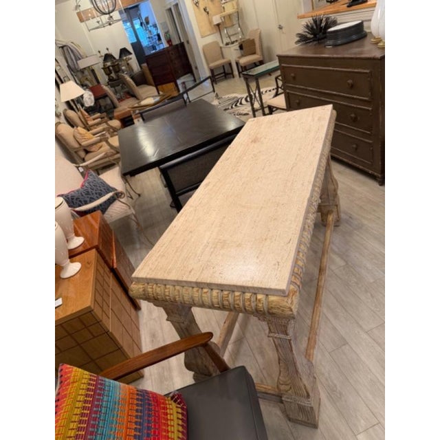 This is a beautiful cerused oak and travertine console table by Baker. The base is simply carved with a stunning washed...