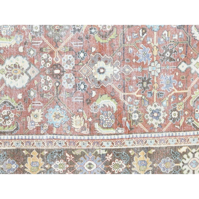 This Antique Persian Mahal Rug, measuring 8'6" x 11'6", showcases intricate traditional designs and vivid colors, adding a...