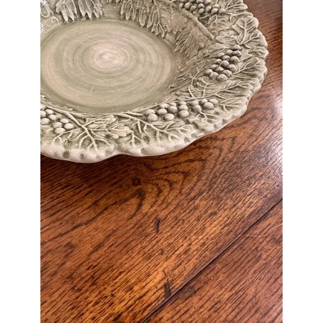 This is a Williams Sonoma Sage Napa dessert plate. These are made of ceramic with a grapevine motif and a green glaze. We...