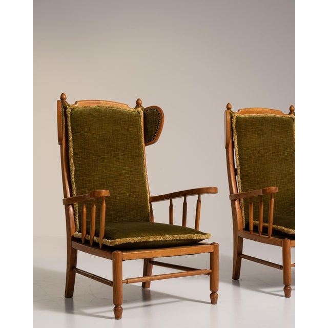 A brown wood lounge chair, dating to the 1970s and made in France. The wood frame is finished in fabric, combining...