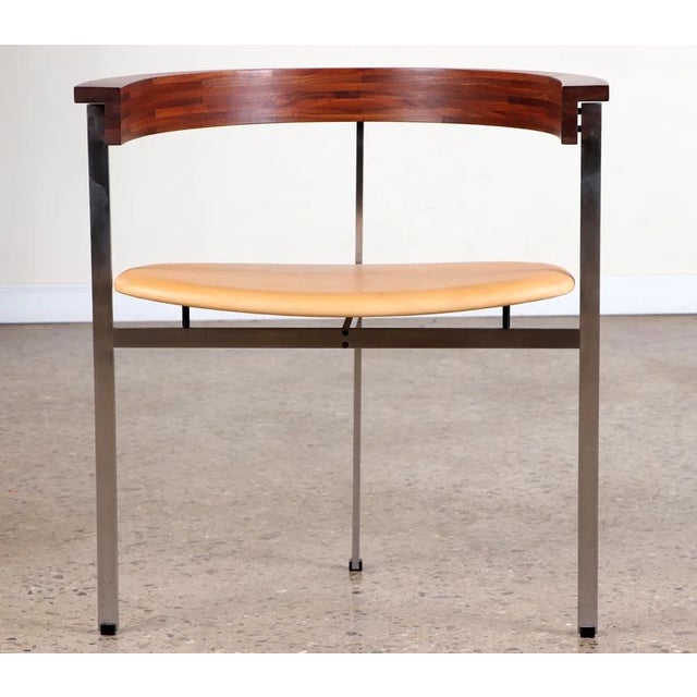 A matching pair of PK 11 armchairs. Each iconic chair consists of three spring steel legs, joined with machine screws. The...