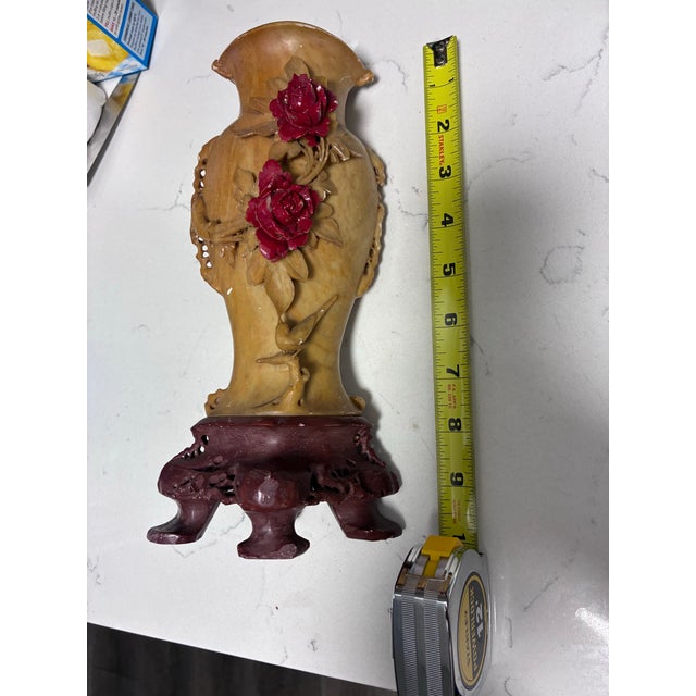 This carved soapstone vase is in good vintage condition with moderate age-related wear. The vase displays minor surface...