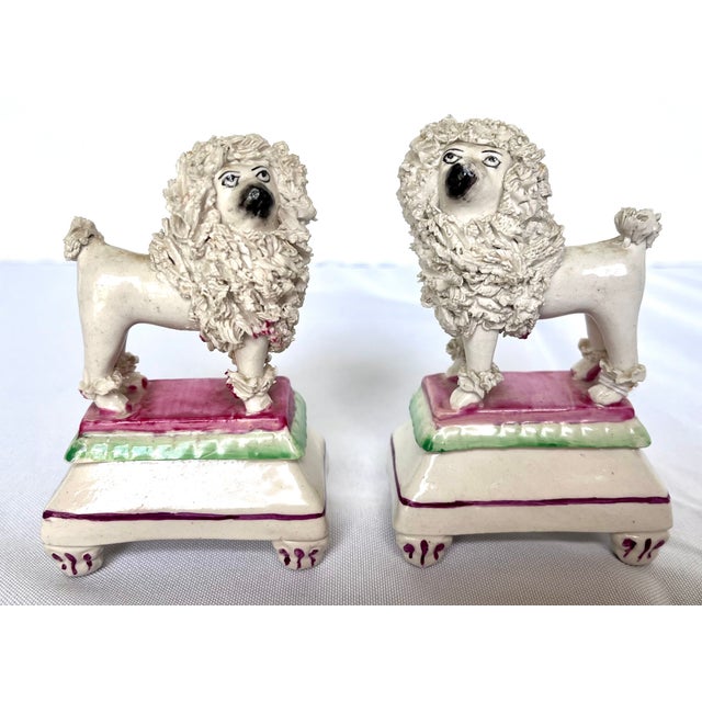 Charming and highly collectible, this authentic pair of 19th-century Victorian English Staffordshire poodle figurines adds...