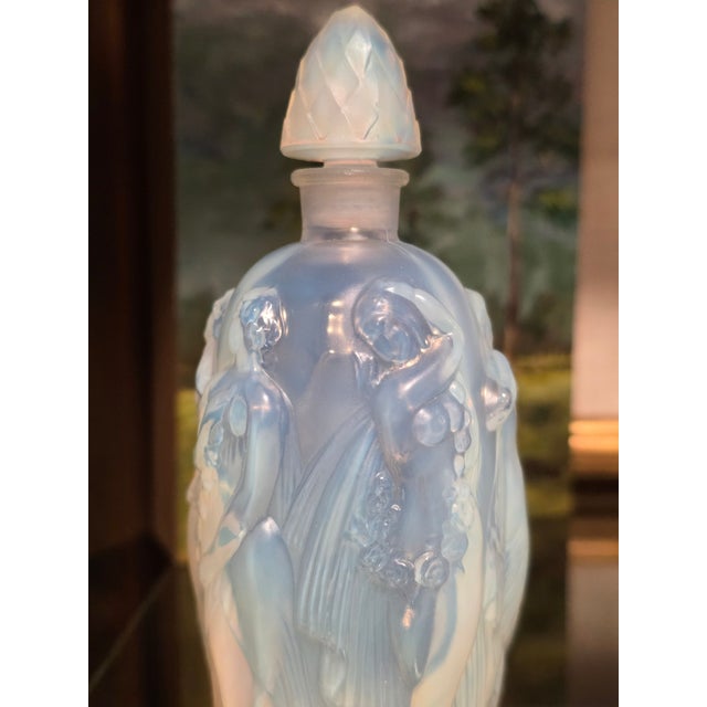 Beautiful antique French Sabino Art Glass perfume bottle with women around the surface.