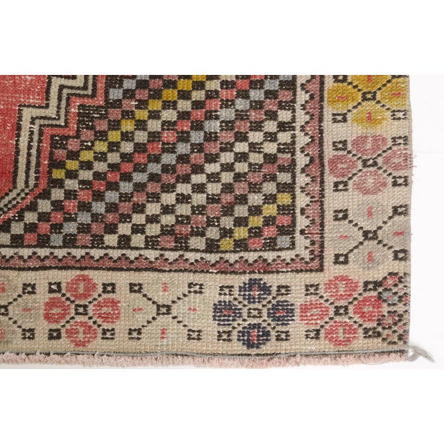 This is a vintage Turkish Oushak rug from the Mid 20th Century. The piece was hand-knotted.