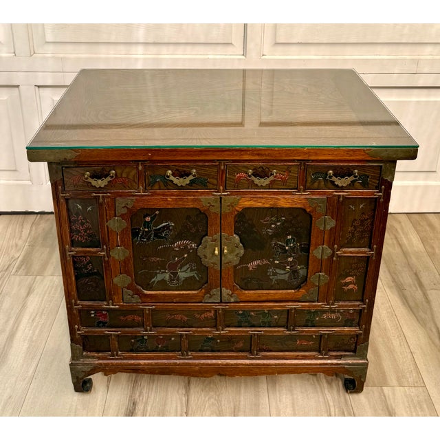 Here is a vintage, roughly later mid-century Asian Korean cabinet, featuring detailed hand-painted hunting and animal...