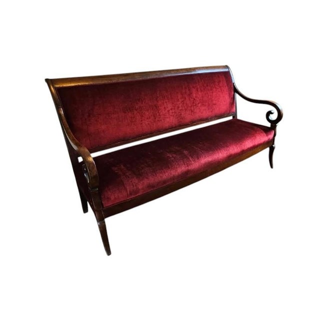 A beautifully proportioned French Louis Philippe style walnut settee showcasing the timeless elegance of nineteenth-...