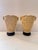 A pair of intricately carved vases crafted from a resin‑based composite material, featuring detailed relief scenes of...