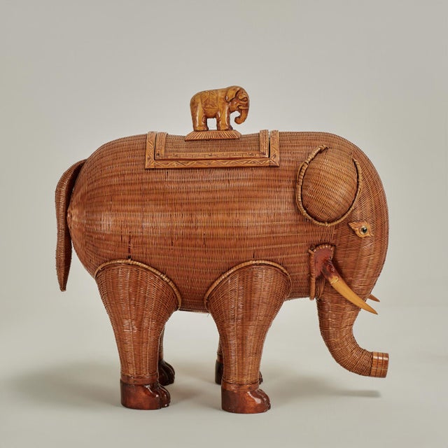 Charming vintage Chinese elephant box handcrafted in wicker with carved wood highlights including an elephant lid handle....