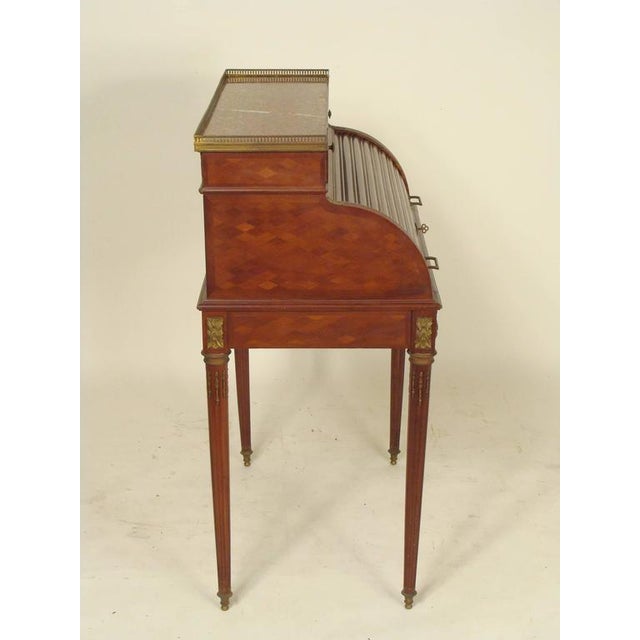 Louis XVI style mahogany cylinder desk with bronze mounts and a marble top, circa 1900. This desk has a nice quality...