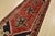 An authentic vintage tribal Karajeh runner hand-knotted with fine wool and natural dyes. This nomadic rug features three...