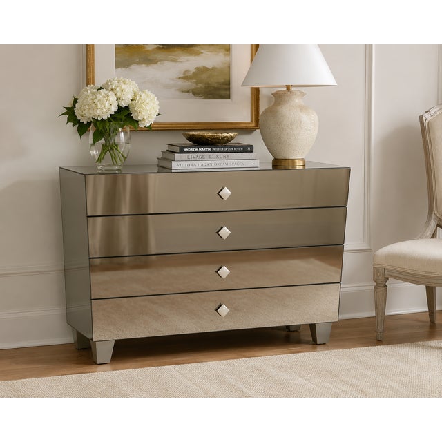 A sophisticated contemporary mirrored chest finished in subtle bronze-smoked mirror, offering a warmer and more refined...