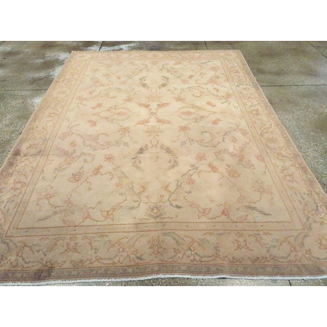 An antique Turkish Oushak accent carpet. Leaves, leaves everywhere, but few flowers, on the lightest tan ground of this...