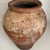 Antique rustic terra-cotta Turkish vessel pot with weathered surface and warm patina. Aged, imperfect aesthetic decor piece.