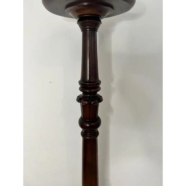 Antique Victorian quality carved mahogany torchere having a circular mahogany top with a moulded edge supported by a...