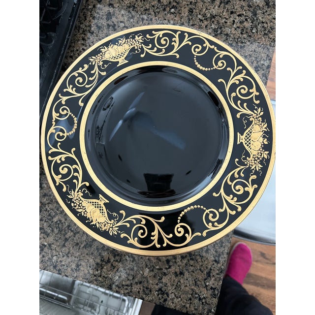 Ten elegant antique Bohemian black glass chargers richly decorated with hand-applied raised gilt enamel in a classical...