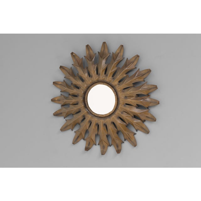 Steel sun burst mirror with original painted finish. Circa 1950.