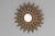 Steel sun burst mirror with original painted finish. Circa 1950.
