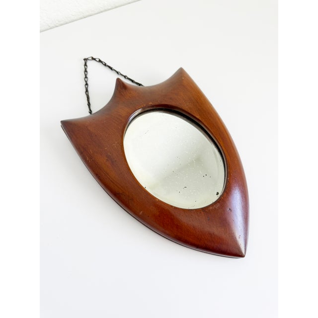 A small Italian Art Deco-style mirror from the early to mid-20th century, reminiscent of shapes and materials used by...