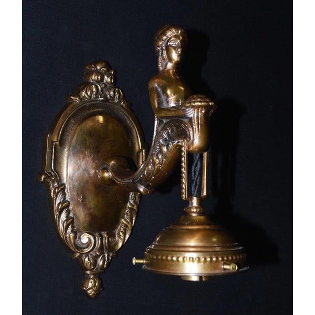 A striking French figural wall light combining classical Empire-inspired decoration with the sculptural character of early...