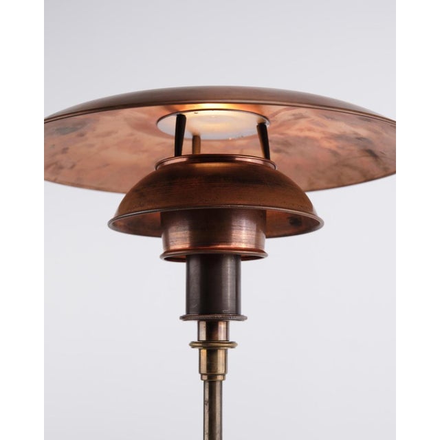 Ph 3/2 table lamp designed by poul henningsen and produced by louis poulsen. The lamp is made with copper shades and a...