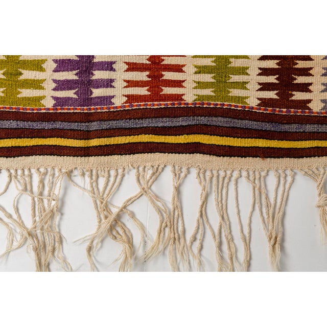 This is a vintage Turkish Oushak rug from the Mid 20th Century. The piece was hand-knotted.