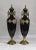 Grand Tour Tall Neoclassic Style Heavy Ceramic Black Colored Vases/Urns Mounted to Round Brass Bottoms Accented by Extended Brass Handles - A Pair For Sale - Image 3 of 12