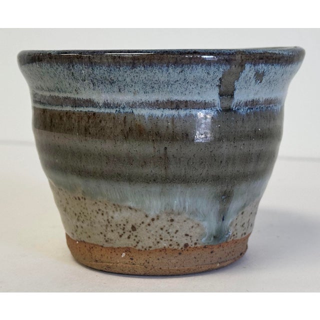 Vintage handmade studio pottery clay trinket bowl featuring blue tone drip glaze over speckled gray and brown base. Age...