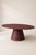 Burgundy red microcement oval table, custom-made by Andrea Toffanin, Hood – Back & Forth Design. The essential shape of...