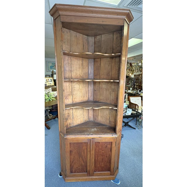 Awesome 19th century corner cabinet. This rustic piece is made of pine in one piece. There are four fixed shelves with a...