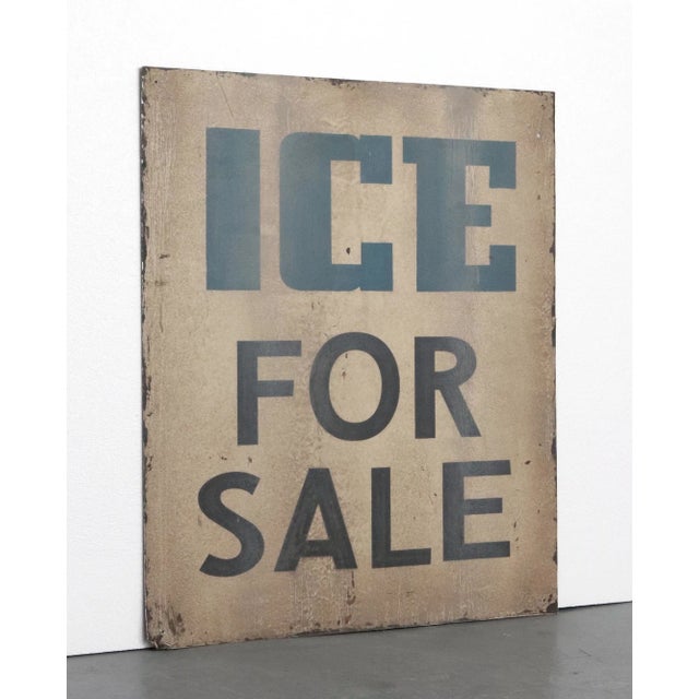 Reclaimed movie set sign made of aluminum in grayish-white, blue, and black colors. The sign reads "Ice for Sale". There...