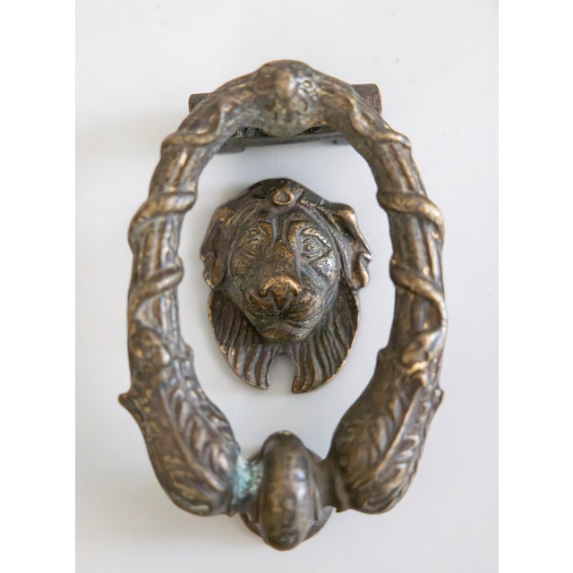A fine antique 19th Century French brass lion door knocker including all three original pieces (the knocker, lion head,...