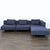 This CB2 sectional sofa features a sleek modern design with dark blue fabric and chrome metal legs. It includes three...