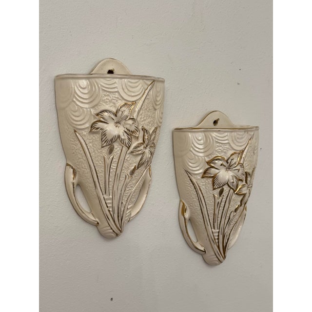 A lovely and elegant pair of Art Deco style ceramic wall pockets. This pair is believed to be created during the 1930's in...