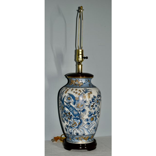 Vintage (1970's) Table Lamp has an Asian Style. Made of Porcelain in a Blue & White Floral Pattern. The lamp is Electric....