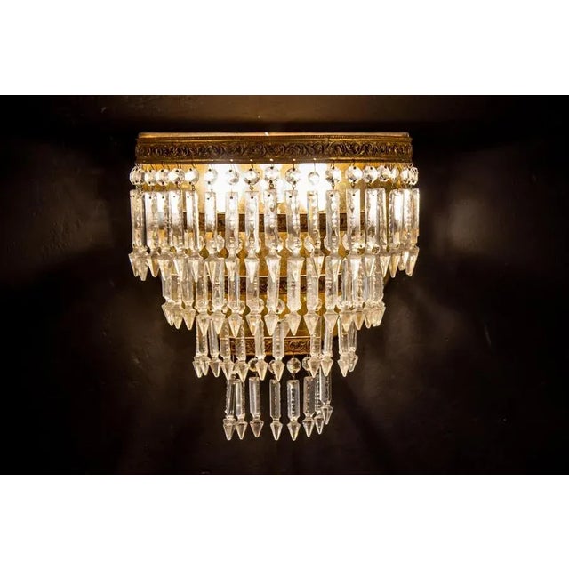 This amazing oval shaped sconces supporting a set of precious cut crystal prisms and octagons on bronze gilded frame....