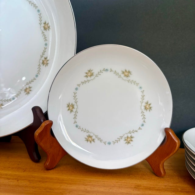 Delicate vintage bread-and-butter plates from the Wyndham “Buttercup” pattern, featuring soft yellow and blue florals...