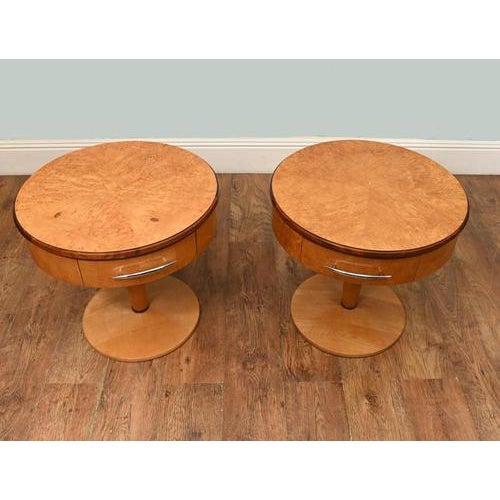 A stylish pair of Art Deco burr walnut bedside tables, dating to the 1930s. Each table features a circular top beautifully...