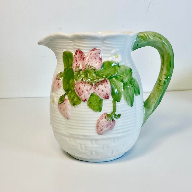 This is so lovely. It’s a ceramic pitcher with raised relief strawberries and leaves on a white faux woven basket pitcher....