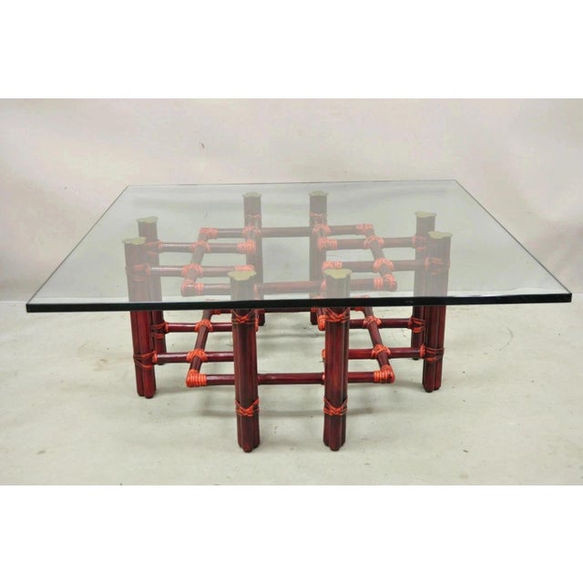 Vintage McGuire Red Rattan Bamboo and Brass Glass Top Square Coffee Table. Item features thick clear glass top, red...