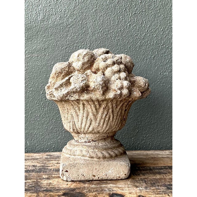 This vintage cast stone fruit basket sculpture beautifully captures the timeless elegance of classical garden...