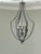 A striking large-scale chandelier featuring a sculptural open-frame silhouette and an elegant silver-tone finish....